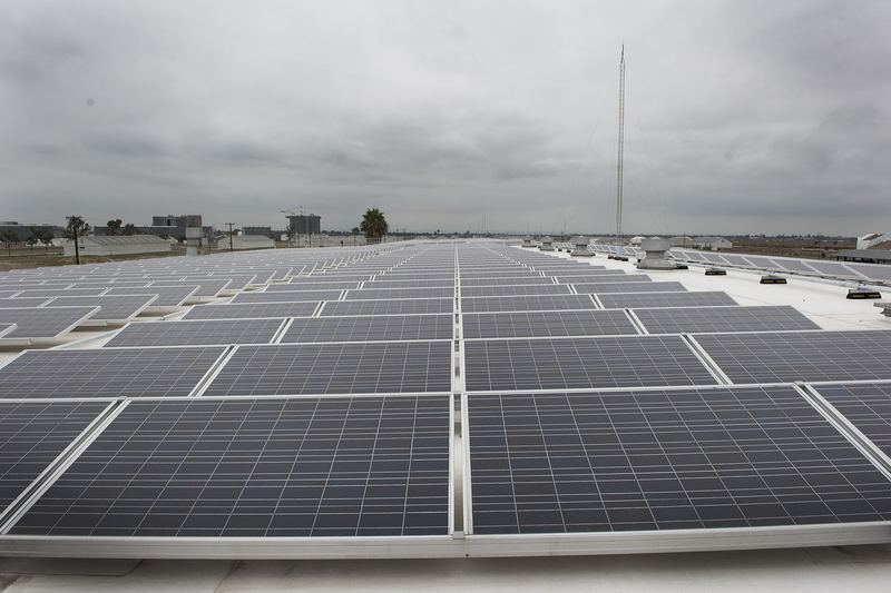 Solar installers working on a rooftop photovoltaic array